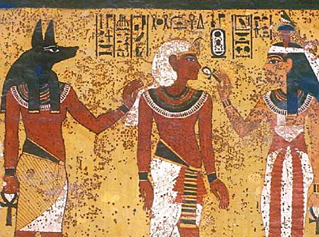 Front Wall, Right Part, Tutankhamun's Burial Chamber - god Anubis, on left, leads Tutankhamun before goddess Hathor, on right, who gives the breath of life to King Tut through the nostrils with the ankh.  The symbols of life, prosperity, time and eternity are directly over Tut's head.