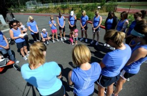 Running group Run to Remember joins in a prayer circle before a run.